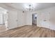 Bright bedroom featuring wood-look floors, modern lighting, closet, and an ensuite bathroom at 8101 W Flamingo Rd # 1035, Las Vegas, NV 89147