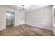 Bright bedroom featuring hardwood floors, a modern ceiling fan, and access to the bathroom at 8101 W Flamingo Rd # 1035, Las Vegas, NV 89147