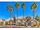 Community clubhouse with desert landscaping, large arched entryway and palm trees at 8101 W Flamingo Rd # 1035, Las Vegas, NV 89147