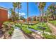 Exterior shot of buildings with walkway, barbecue, grass, trees, flowers, and lush landscaping at 8101 W Flamingo Rd # 1035, Las Vegas, NV 89147