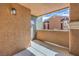 Cozy patio area with textured walls and a glimpse of neighboring buildings at 8101 W Flamingo Rd # 1035, Las Vegas, NV 89147