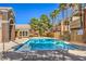 Community pool with palm trees, desert landscaping, and lounge chairs at 8101 W Flamingo Rd # 1035, Las Vegas, NV 89147