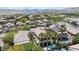 Aerial view showcasing a community with well-maintained landscaping, palm trees, tile roofs, and a private pool at 820 Colina Alta Pl, Las Vegas, NV 89138