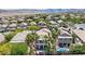 Scenic aerial view of the property, nestled in a vibrant neighborhood with views of nearby mountains at 820 Colina Alta Pl, Las Vegas, NV 89138