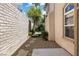 A peaceful backyard side yard with a well-maintained walkway and view of the pool at 820 Colina Alta Pl, Las Vegas, NV 89138