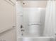 Close-up of a clean, well-maintained bathtub and shower with white tile and shower curtain at 820 Colina Alta Pl, Las Vegas, NV 89138