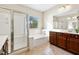 Bright bathroom with a walk-in shower and a soaking tub by the window at 820 Colina Alta Pl, Las Vegas, NV 89138
