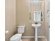 Compact half-bathroom featuring a pedestal sink and toilet, conveniently located for guests at 820 Colina Alta Pl, Las Vegas, NV 89138