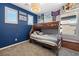 Bedroom featuring a wooden bunk bed, blue accent wall, and carpet flooring at 820 Colina Alta Pl, Las Vegas, NV 89138