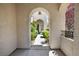 Exterior archway and walkway surrounded by mature landscaping at 820 Colina Alta Pl, Las Vegas, NV 89138