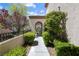 Beautifully landscaped walkway leading to an arched entry at 820 Colina Alta Pl, Las Vegas, NV 89138