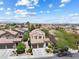 Expansive view of a two-story home featuring a tile roof, desert landscaping, and mountain views at 820 Colina Alta Pl, Las Vegas, NV 89138