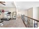 Hallway with fitness equipment on the side and a wrought iron banister overlooking the stairs at 820 Colina Alta Pl, Las Vegas, NV 89138