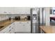 Updated kitchen featuring stainless appliances, granite countertops, and abundant white cabinets at 820 Colina Alta Pl, Las Vegas, NV 89138