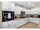 Well-equipped kitchen with ample white cabinetry, stainless microwave and granite countertops at 820 Colina Alta Pl, Las Vegas, NV 89138