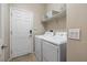 Well-equipped laundry room with modern washer and dryer, plus ample storage solutions at 820 Colina Alta Pl, Las Vegas, NV 89138