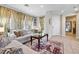 Cozy living room with a large window, neutral decor, and ample natural light at 820 Colina Alta Pl, Las Vegas, NV 89138