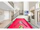 Well-lit living area features a pool table and staircase at 820 Colina Alta Pl, Las Vegas, NV 89138