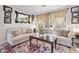 Cozy living room showcases neutral furniture, decorative pillows and a unique mirror at 820 Colina Alta Pl, Las Vegas, NV 89138
