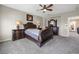 Elegant main bedroom with dark wood furniture, neutral walls, and cozy carpet at 820 Colina Alta Pl, Las Vegas, NV 89138