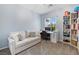Bright and airy office space with a comfortable couch, desk setup, and built-in shelves at 820 Colina Alta Pl, Las Vegas, NV 89138