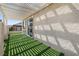 Covered patio with artificial turf and access to the house via a sliding door at 820 Colina Alta Pl, Las Vegas, NV 89138