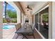 Covered patio featuring an outdoor dining area, perfect for enjoying meals while overlooking the beautiful backyard at 820 Colina Alta Pl, Las Vegas, NV 89138