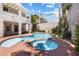 Backyard oasis with a private pool, jacuzzi, and lush landscaping at 820 Colina Alta Pl, Las Vegas, NV 89138