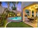 Desert backyard oasis featuring a pool, spa, patio, seating and manicured desert landscaping at 820 Colina Alta Pl, Las Vegas, NV 89138