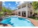Inviting backyard with a pool and a beautiful two-story house at 820 Colina Alta Pl, Las Vegas, NV 89138