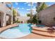 Inviting backyard pool and spa area with lush landscaping, perfect for relaxation and entertaining in this beautiful home at 820 Colina Alta Pl, Las Vegas, NV 89138