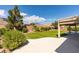 Large backyard with well-manicured landscaping and mountain views from a covered patio at 8204 Turbys Treehouse Pl, Las Vegas, NV 89131