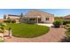 Expansive backyard featuring artificial turf, desert landscaping, and a covered patio at 8204 Turbys Treehouse Pl, Las Vegas, NV 89131
