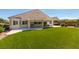 Spacious backyard with low-maintenance turf and a covered patio, ideal for outdoor entertaining at 8204 Turbys Treehouse Pl, Las Vegas, NV 89131