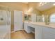 Bathroom features a double sink vanity, tiled floors, and a glass enclosed shower with a tub at 8204 Turbys Treehouse Pl, Las Vegas, NV 89131