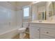 This bathroom has a shower/tub, toilet, vanity, and framed mirror at 8204 Turbys Treehouse Pl, Las Vegas, NV 89131