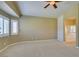 This primary bedroom boasts plush carpet, neutral paint, a ceiling fan, and a shuttered window at 8204 Turbys Treehouse Pl, Las Vegas, NV 89131