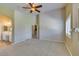 Bright bedroom showcasing vaulted ceilings, neutral carpet, and an ensuite bathroom and walk-in closet at 8204 Turbys Treehouse Pl, Las Vegas, NV 89131