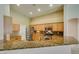 Bright kitchen featuring granite countertops, tile flooring, and stainless steel appliances at 8204 Turbys Treehouse Pl, Las Vegas, NV 89131