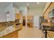 Bright eat-in kitchen featuring granite countertops, tile flooring, and stainless steel appliances at 8204 Turbys Treehouse Pl, Las Vegas, NV 89131