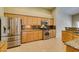 Bright kitchen featuring granite countertops, stainless steel appliances, and wood cabinets at 8204 Turbys Treehouse Pl, Las Vegas, NV 89131