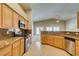 Bright eat-in kitchen with tile floors, granite counters, stainless appliances, and backyard views at 8204 Turbys Treehouse Pl, Las Vegas, NV 89131