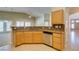Bright eat-in kitchen featuring granite countertops, stainless steel appliances, and wood cabinets at 8204 Turbys Treehouse Pl, Las Vegas, NV 89131