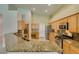 Bright eat-in kitchen featuring granite countertops, tile flooring, and stainless steel appliances at 8204 Turbys Treehouse Pl, Las Vegas, NV 89131