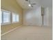 Bright living room featuring vaulted ceilings, modern fan, and white shutters at 8204 Turbys Treehouse Pl, Las Vegas, NV 89131