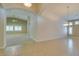 Spacious living room with ceramic tile flooring and archways leading to other rooms at 8204 Turbys Treehouse Pl, Las Vegas, NV 89131