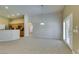 Spacious living room leading to kitchen with wood cabinets and updated lighting at 8204 Turbys Treehouse Pl, Las Vegas, NV 89131