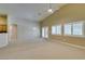 Spacious living room featuring vaulted ceilings, modern fan, and windows with plantation shutters at 8204 Turbys Treehouse Pl, Las Vegas, NV 89131