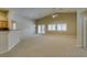Spacious living room with carpet flooring and French doors leading to the backyard at 8204 Turbys Treehouse Pl, Las Vegas, NV 89131