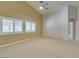 Open-concept living room with vaulted ceilings, fan, and abundant natural light at 8204 Turbys Treehouse Pl, Las Vegas, NV 89131